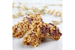 Granola bars with oats and chocolate chunks on wooden table
